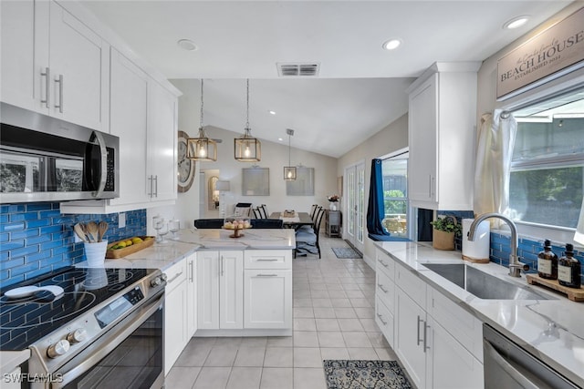 1533 San Marco Rd, Marco Island, FL 34145 - kitchen featuring lofted ceiling, stainless steel appliances, a sink, visible vents, and white cabinets