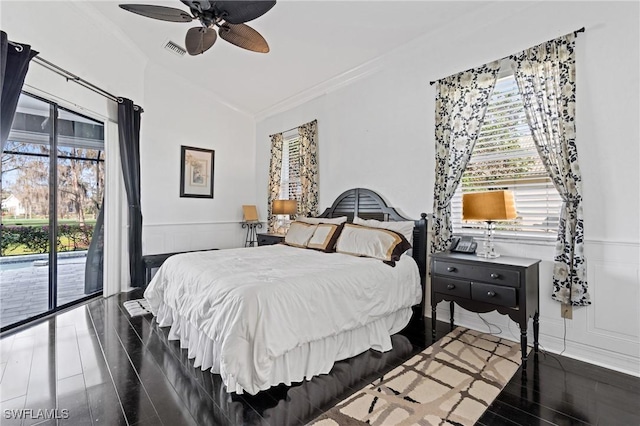 bedroom with multiple windows, crown molding, dark hardwood / wood-style floors, and access to exterior