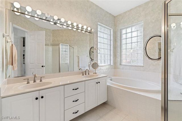 bathroom featuring tile patterned flooring, plus walk in shower, and vanity