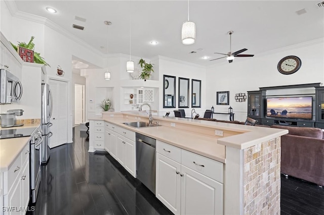 kitchen with sink, an island with sink, white cabinets, and appliances with stainless steel finishes