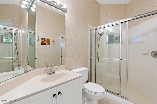 bathroom with vanity, an enclosed shower, and toilet