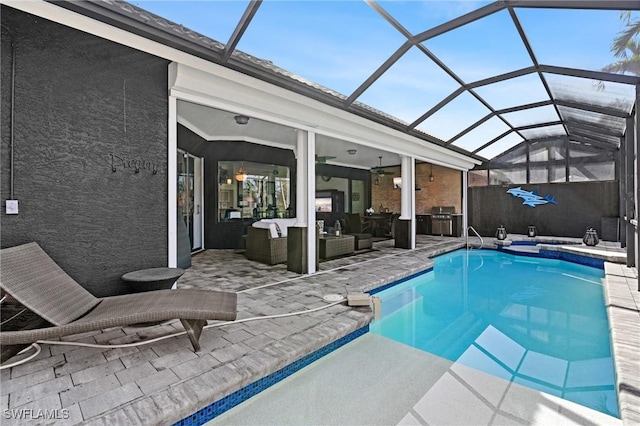 view of swimming pool featuring a lanai, ceiling fan, outdoor lounge area, a patio area, and a jacuzzi