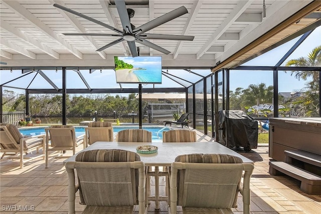 view of patio featuring ceiling fan, glass enclosure, and a pool with hot tub