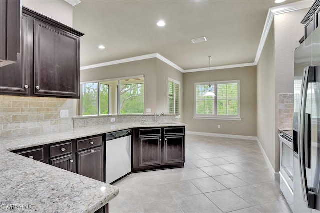 kitchen featuring sink, crown molding, hanging light fixtures, appliances with stainless steel finishes, and backsplash