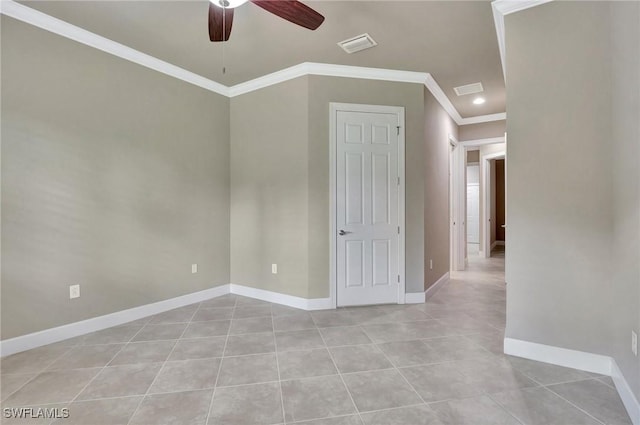 tiled empty room featuring crown molding and ceiling fan