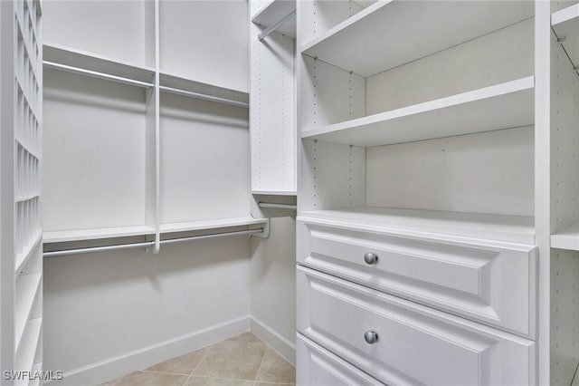 walk in closet featuring light tile patterned flooring