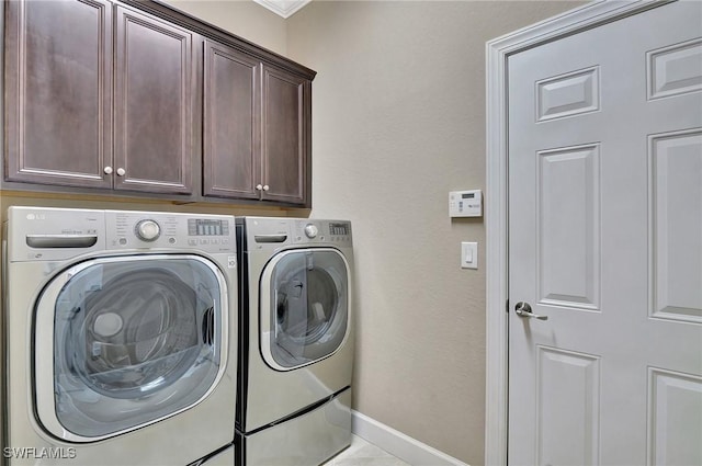 laundry area with cabinets and washer and clothes dryer