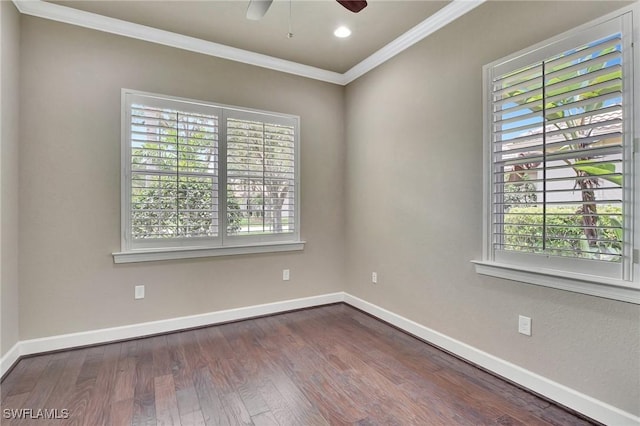 empty room featuring hardwood / wood-style flooring, ornamental molding, and a healthy amount of sunlight