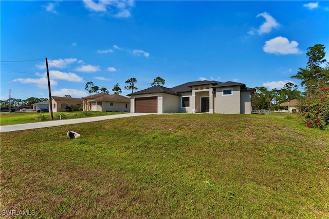 view of front of home featuring a garage and a front yard