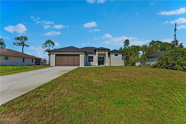 view of front of home featuring a garage and a front yard