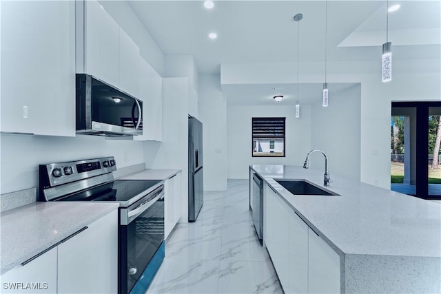 kitchen with stainless steel appliances, hanging light fixtures, sink, and white cabinets