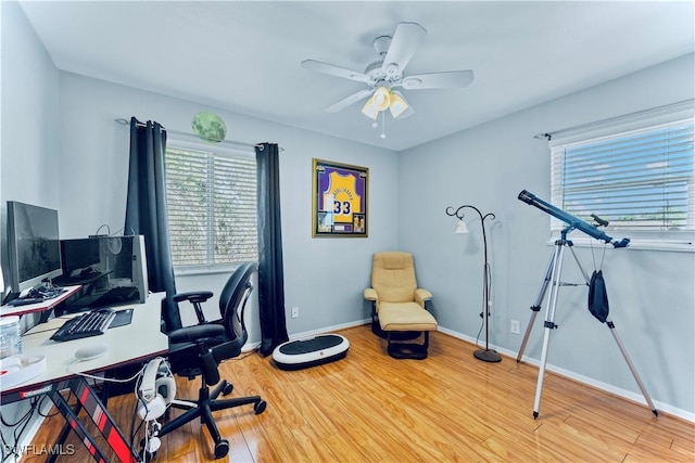 home office with ceiling fan and light wood-type flooring