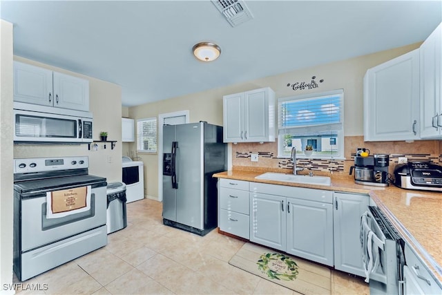 kitchen featuring white cabinetry, stainless steel appliances, sink, and tasteful backsplash