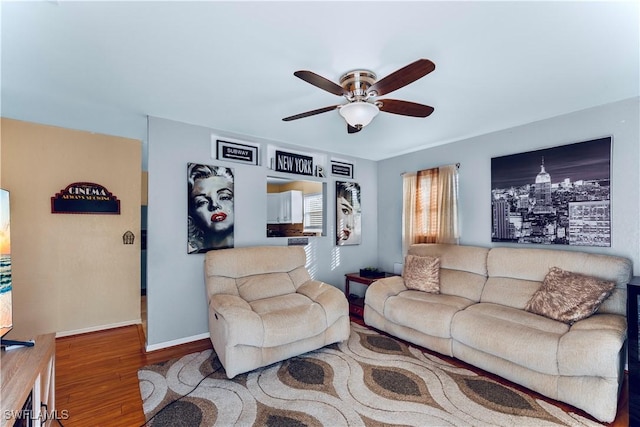 living room with wood-type flooring and ceiling fan