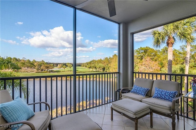 sunroom with a water view, a healthy amount of sunlight, and ceiling fan