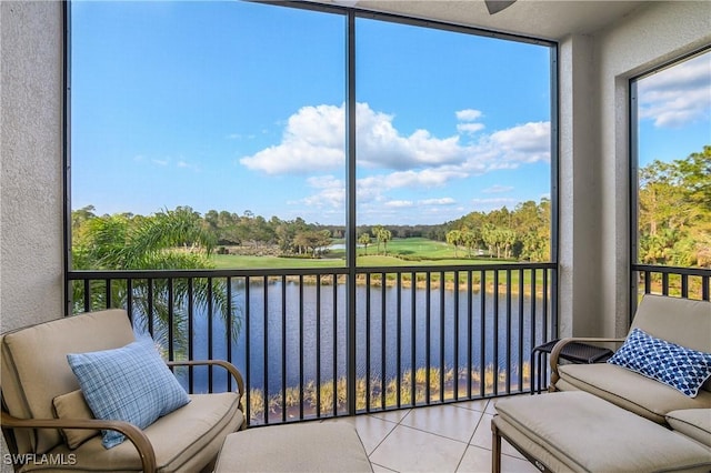 sunroom / solarium featuring a water view