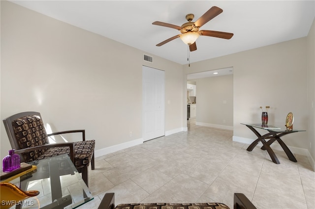 sitting room featuring ceiling fan and light tile patterned floors