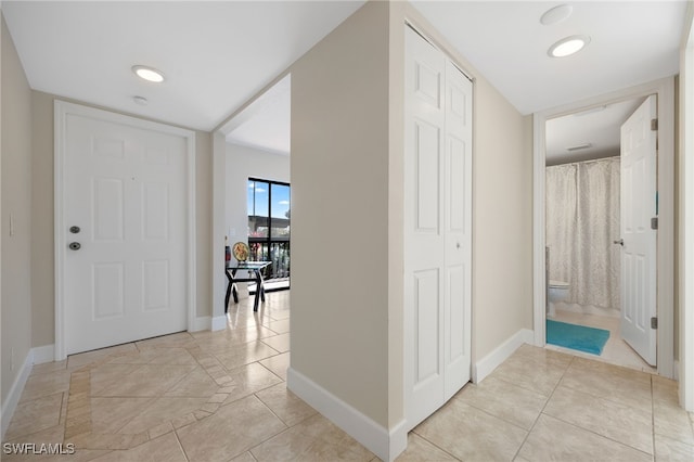 corridor featuring light tile patterned flooring