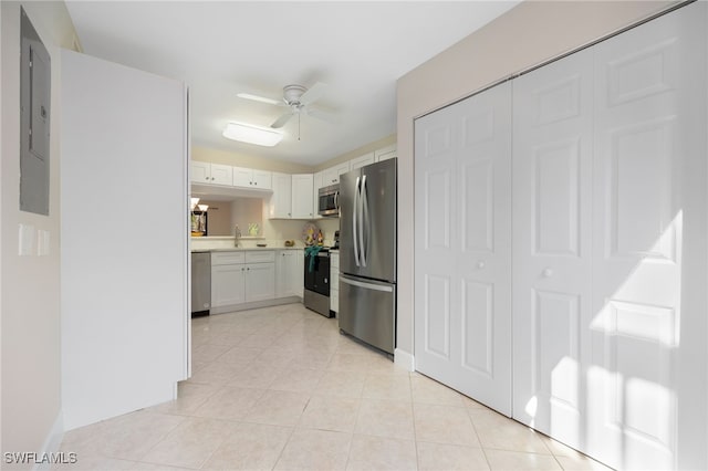 kitchen featuring white cabinetry, light tile patterned floors, stainless steel appliances, and ceiling fan