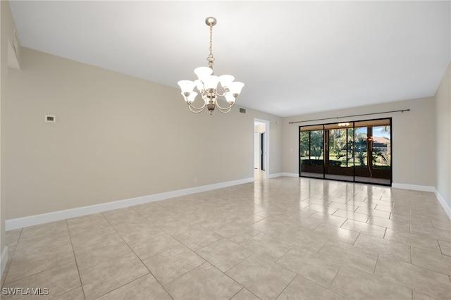 unfurnished room with light tile patterned flooring and a chandelier