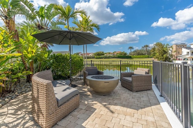 view of patio / terrace with a water view and a fire pit