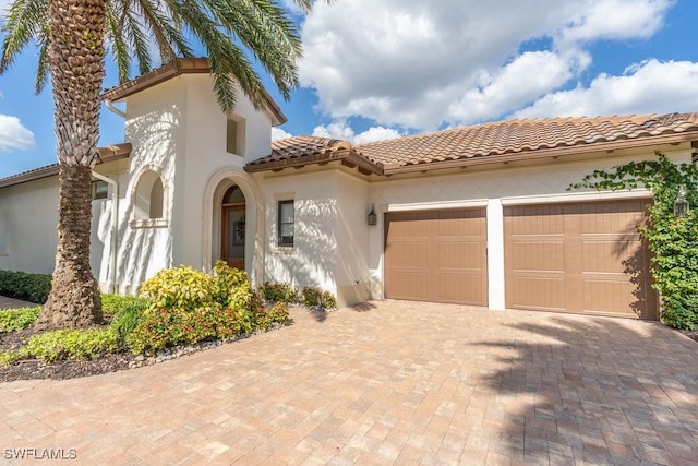 mediterranean / spanish-style house featuring a garage