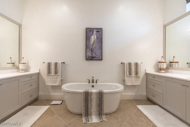 bathroom featuring tile patterned flooring, vanity, and a washtub