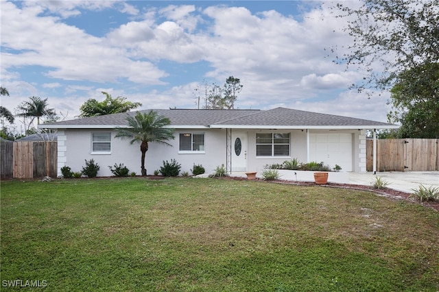 ranch-style house featuring a garage and a front yard