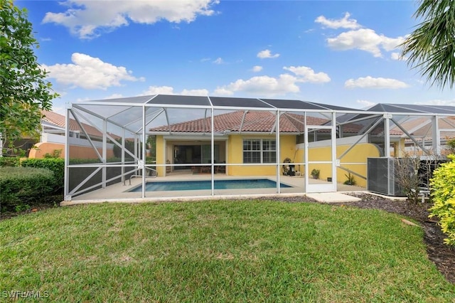 7912 Umberto Ct, Naples, FL 34114 - rear view of property featuring a patio area, glass enclosure, and a lawn