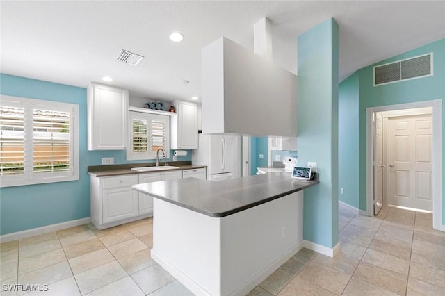 7912 Umberto Ct, Naples, FL 34114 - kitchen with white refrigerator, kitchen peninsula, sink, and white cabinets