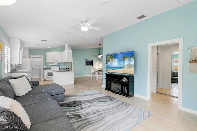 7912 Umberto Ct, Naples, FL 34114 - living room featuring ceiling fan and light hardwood / wood-style flooring
