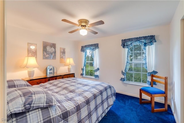 bedroom featuring ceiling fan and dark carpet