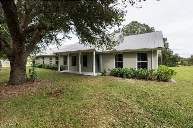 single story home with a front lawn and a patio