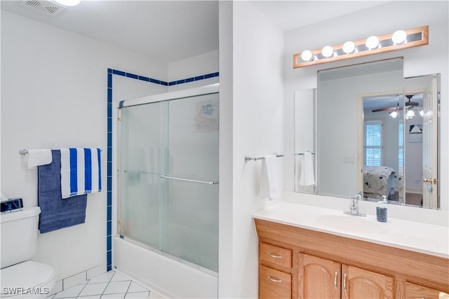 full bathroom featuring enclosed tub / shower combo, vanity, toilet, and tile patterned flooring