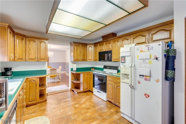 kitchen with a notable chandelier and white appliances