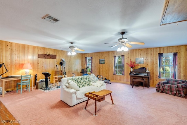 carpeted living room with ceiling fan and plenty of natural light