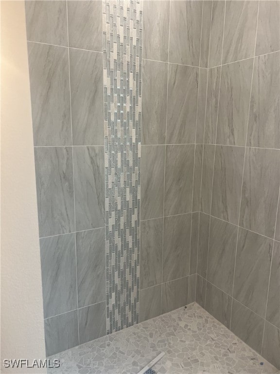 bathroom with a tile shower