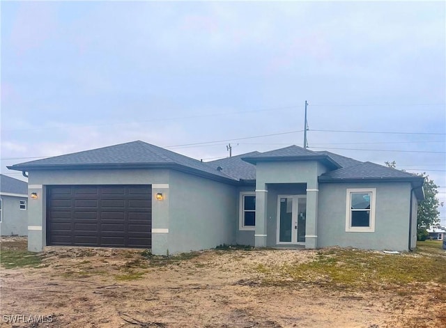 1303 NW Juanita Pl, Cape Coral, FL 33993 - view of front facade with a garage and french doors