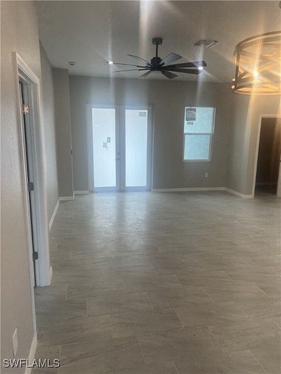 spare room featuring french doors and ceiling fan