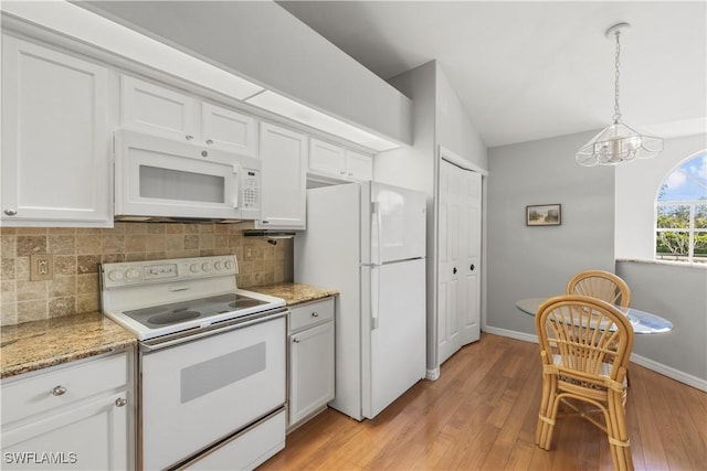 kitchen with white cabinetry, tasteful backsplash, pendant lighting, white appliances, and light hardwood / wood-style floors