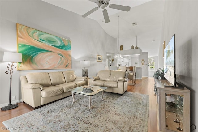 living room featuring ceiling fan, high vaulted ceiling, and hardwood / wood-style floors