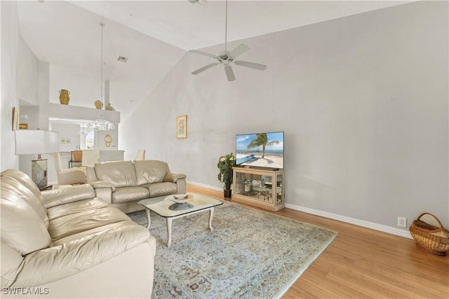 living room featuring ceiling fan, hardwood / wood-style floors, and high vaulted ceiling