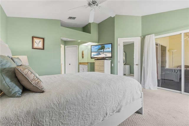 carpeted bedroom featuring ceiling fan, ensuite bathroom, and vaulted ceiling