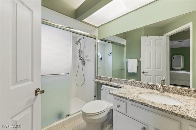 bathroom with vanity, toilet, a shower with shower door, and tile patterned flooring