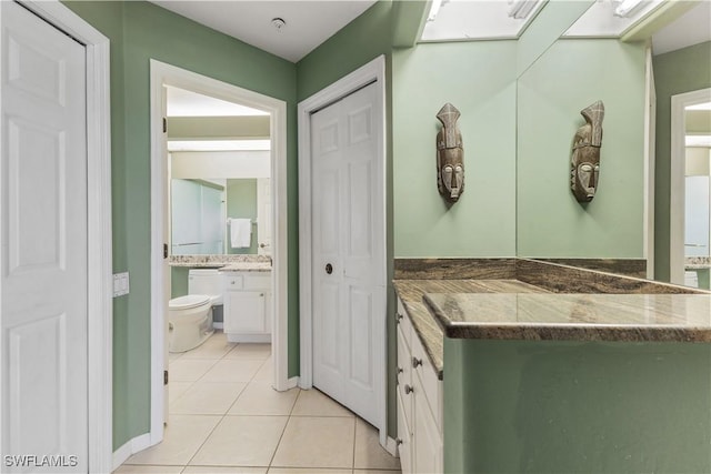 bathroom with vanity, tile patterned floors, and toilet