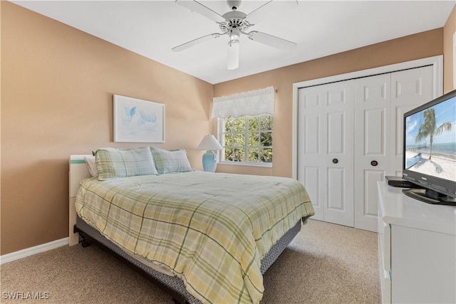 carpeted bedroom with ceiling fan and a closet