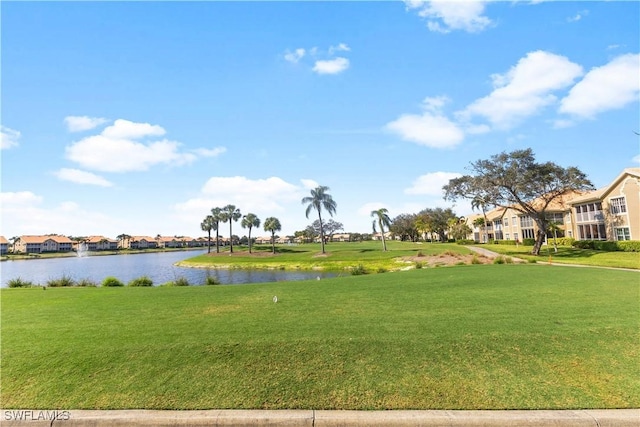 view of property's community with a water view and a yard