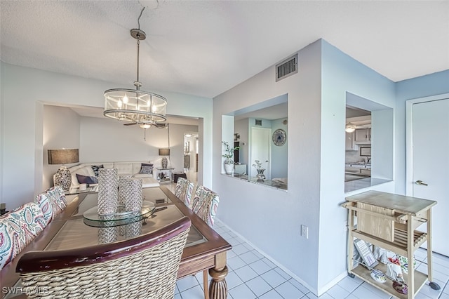 dining room featuring a notable chandelier and light tile patterned floors