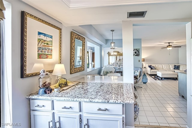 kitchen with light tile patterned flooring, ceiling fan, and decorative light fixtures