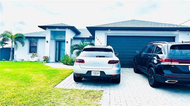 single story home featuring a garage and a front yard